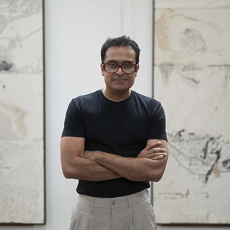 Portrait of Jitish Kallat in front of his works.