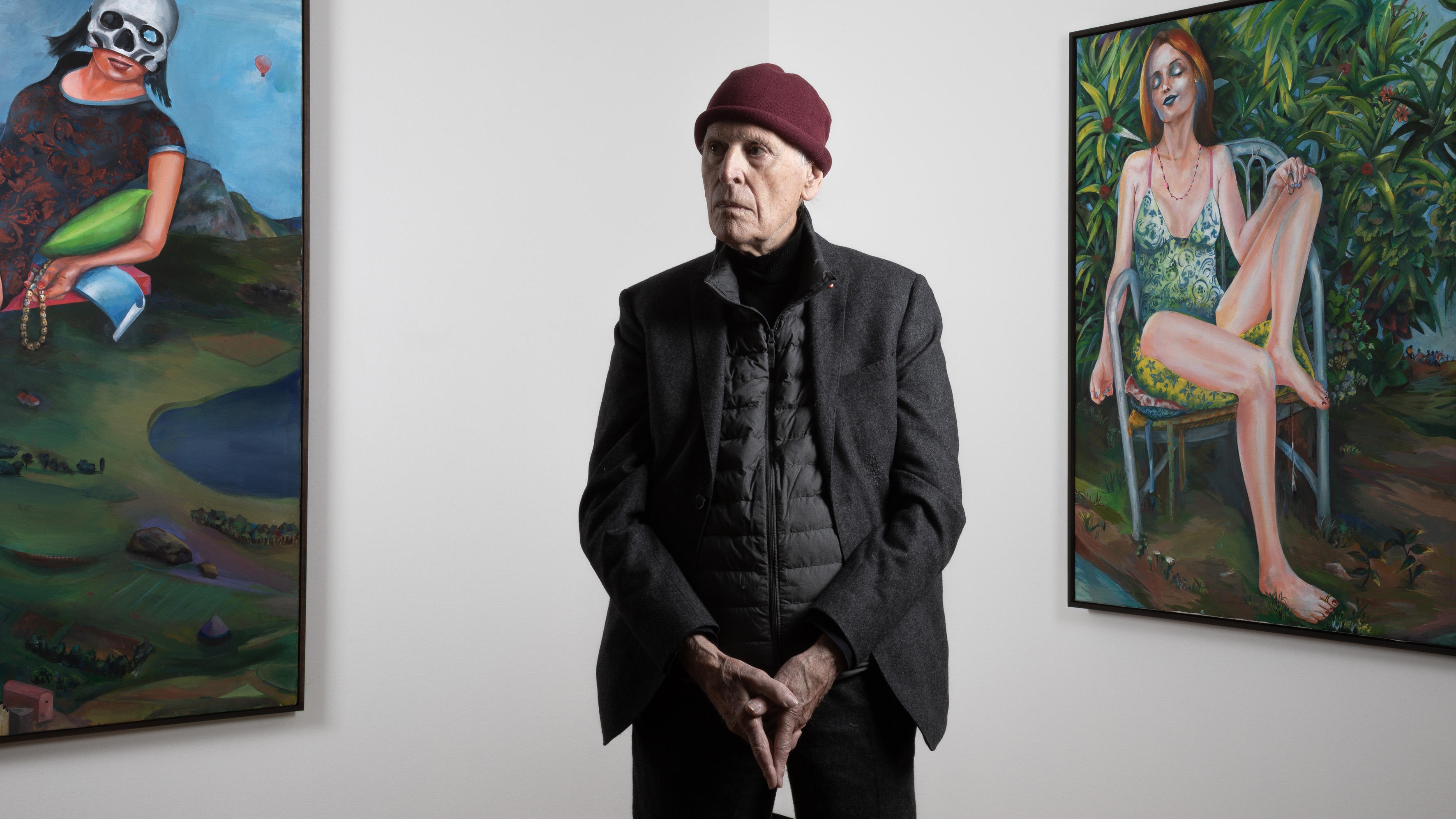 Martial Raysse standing in front of his paintings La Reine du Monde, 2018 (left) and Audrey, 2019 (right)