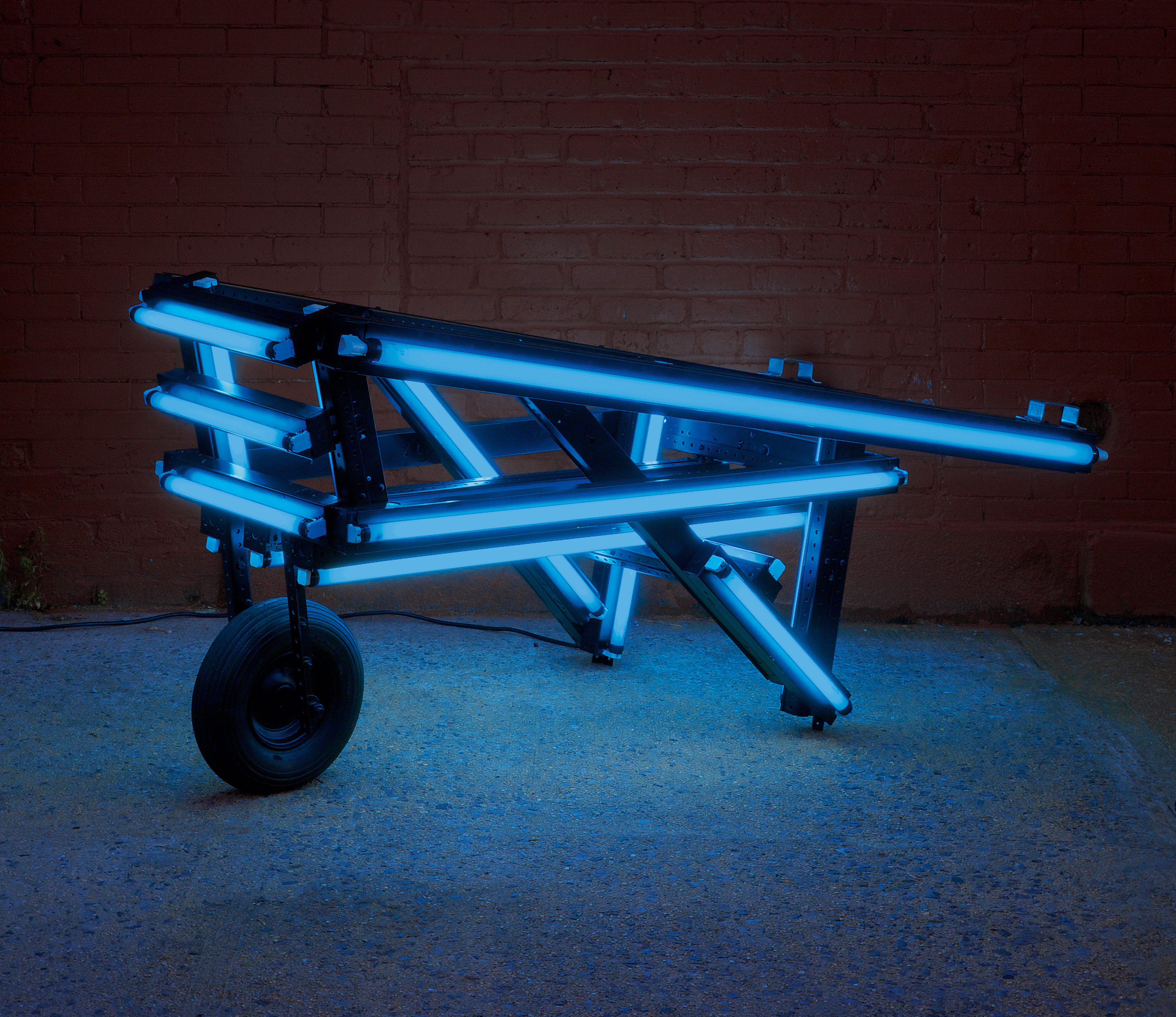 Iván Navarro, Flash light (blue), 2006 Fluorescent light tubes, plastic sleeves, metal fixtures, wheel, video (8:00min) and electric energy 65 × 190 × 80 cm