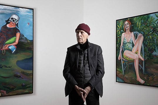 Martial Raysse standing in front of his paintings La Reine du Monde, 2018 (left) and Audrey, 2019 (right)