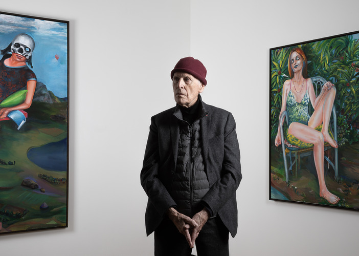 Martial Raysse standing in front of his paintings La Reine du Monde, 2018 (left) and Audrey, 2019 (right)