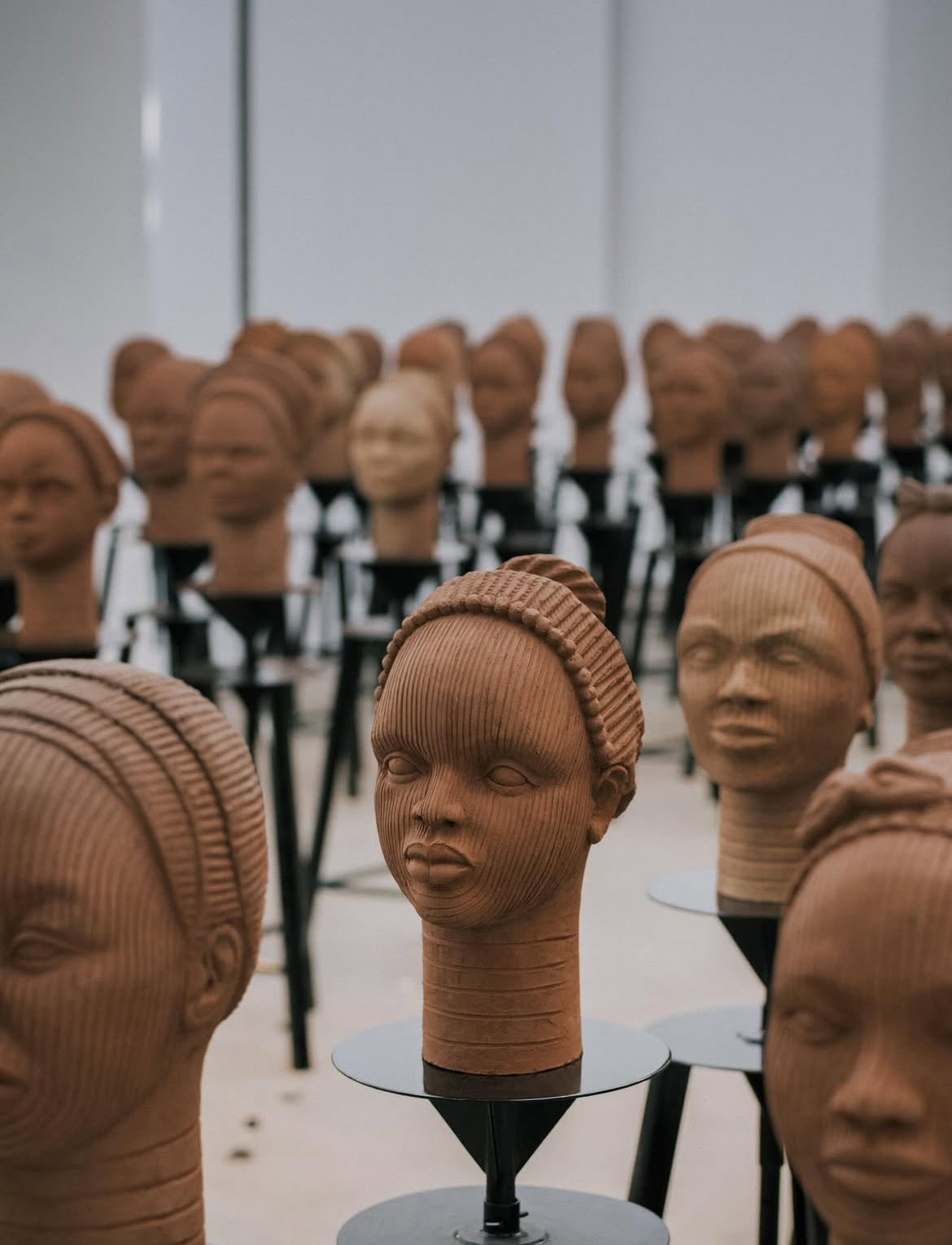 Close up of some of the faces of the Chibok girls, molded by potters and students.