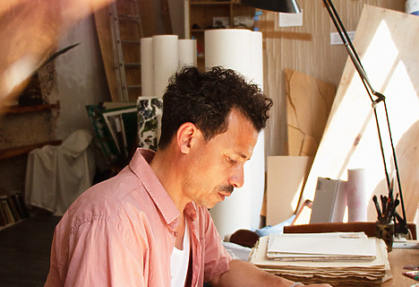 Abdelkader Benchamma working at his desk.