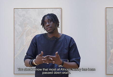 Alioune Diagne in front of is painting Les initiés 2 (2025).